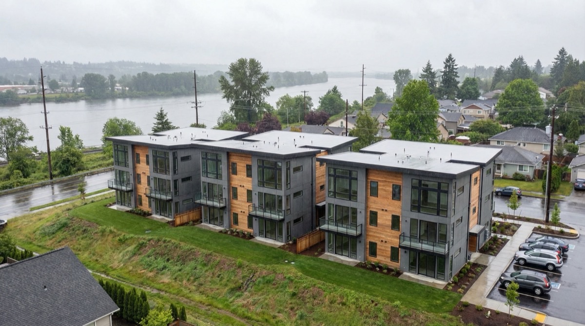 Architectural rendering of standardized fourplex buildings at a riverside development site in Vancouver